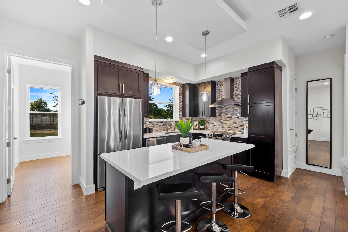 4300 Mansfield Dam Road, Unit 621 Austin, TX 78734 - Photo 3 of 34 a kitchen with kitchen island a refrigerator stove and microwave