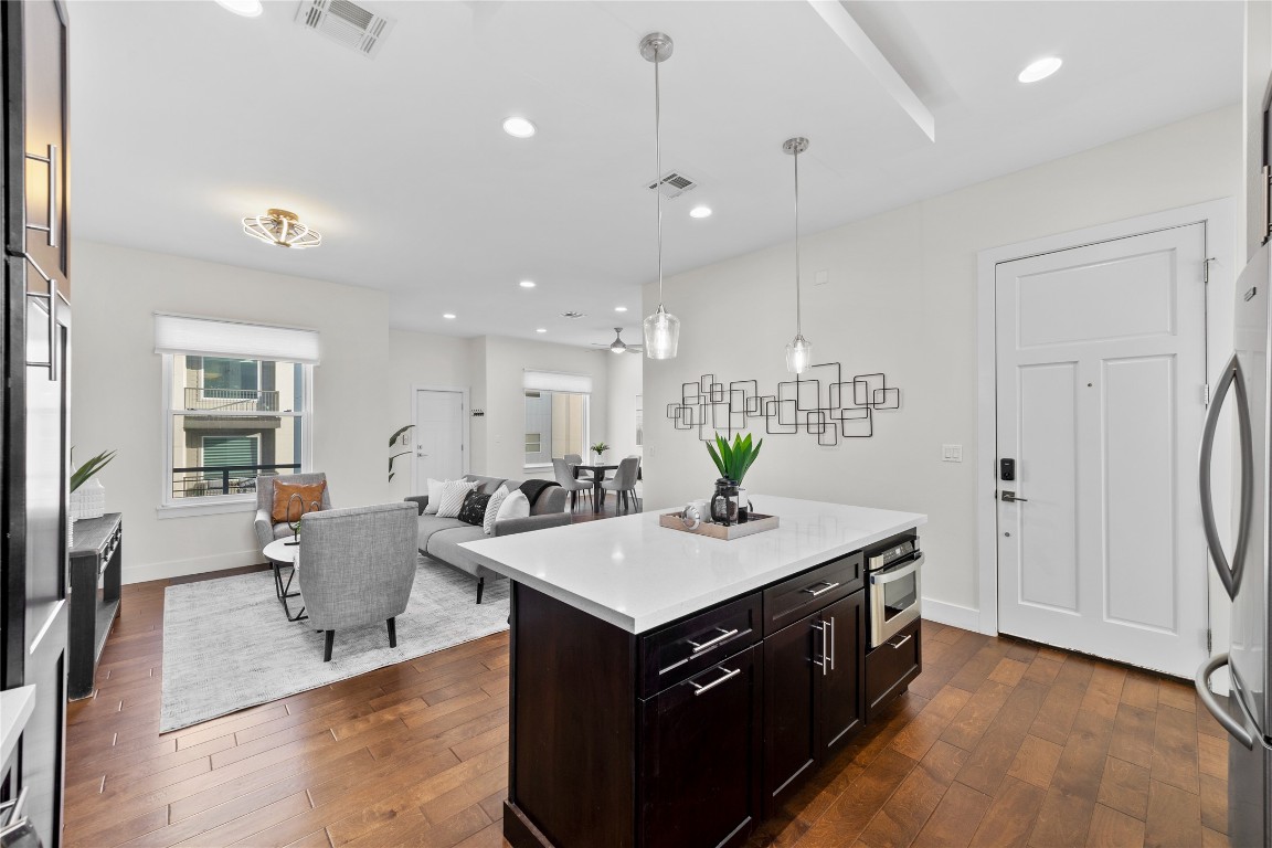 4300 Mansfield Dam Road, Unit 621 Austin, TX 78734 - Photo 6 of 34 a kitchen with a stove a refrigerator and a dining table with wooden floor