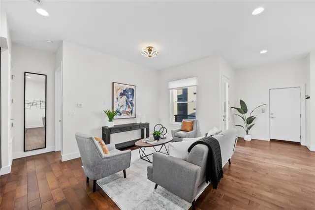 a living room with furniture and a wooden floor