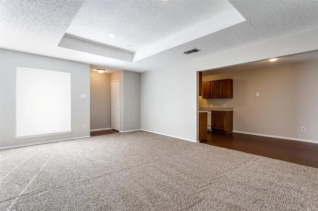 an empty room with closet and a fireplace