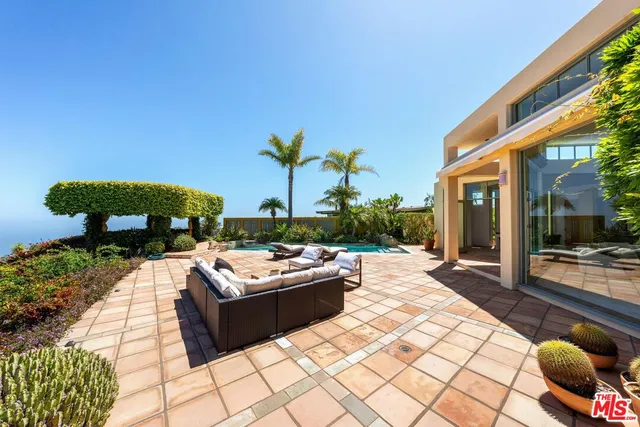 front view of a house with a yard and garage