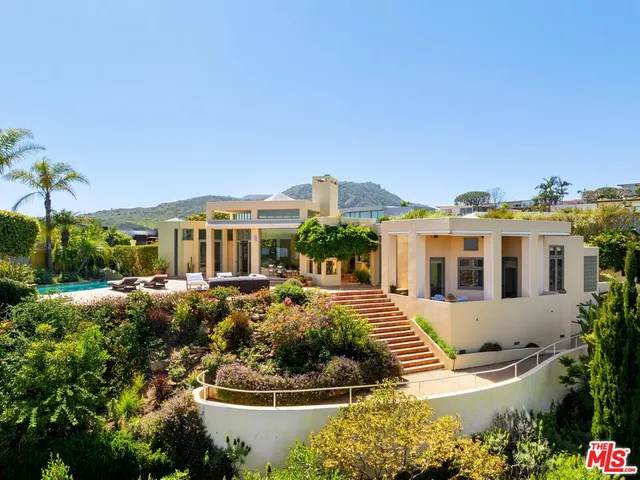 a table and chairs with the view of city