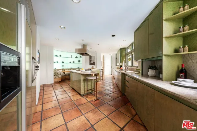 a spacious bedroom with a bed and a flat tv screen on dresser