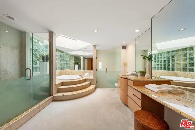 a front view of a house with a yard and potted plants