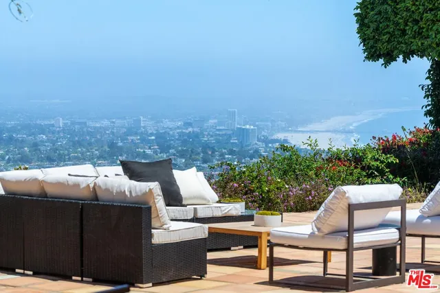 a view of a chairs and table in the patio
