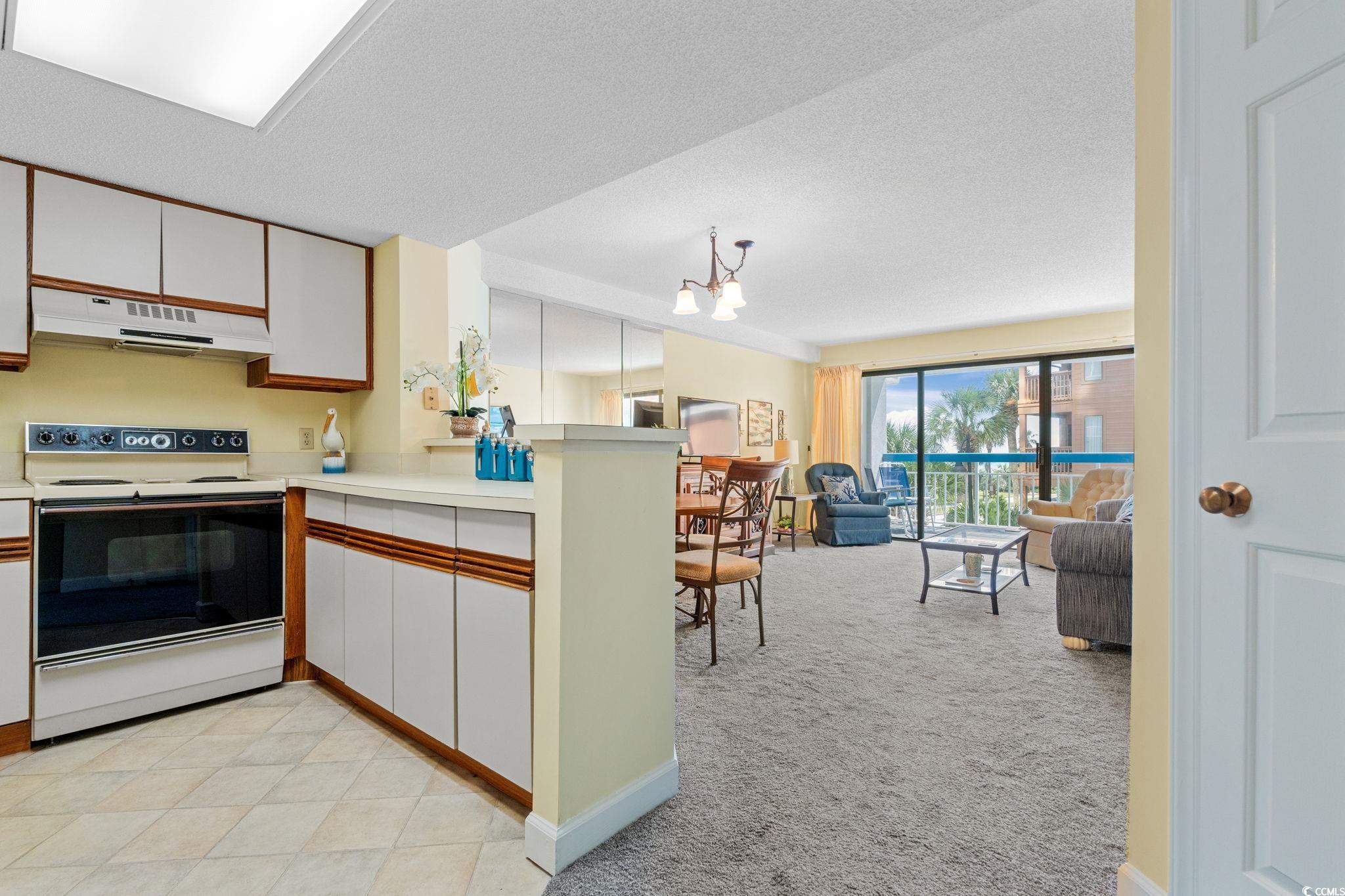 5511 North Ocean Boulevard, Unit 208 Myrtle Beach, SC 29577 - Photo 15 of 37 Kitchen featuring white cabinetry, white electric stove, brown cabinetry, and a textured ceiling