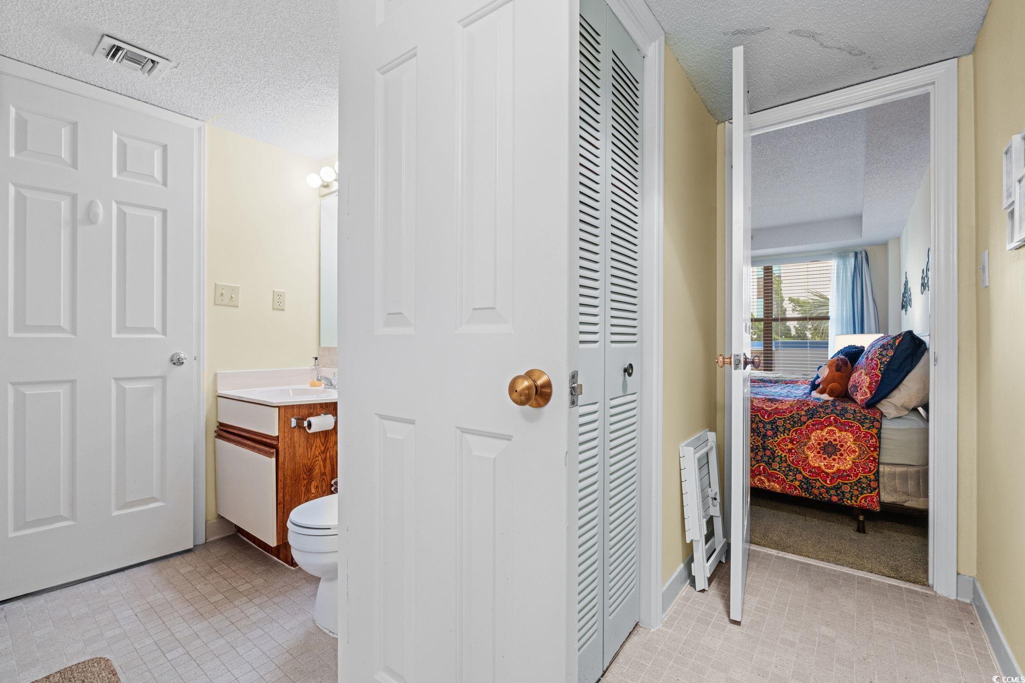 5511 North Ocean Boulevard, Unit 208 Myrtle Beach, SC 29577 - Photo 20 of 37 Bathroom featuring shower / bath combo, vanity, and a textured ceiling