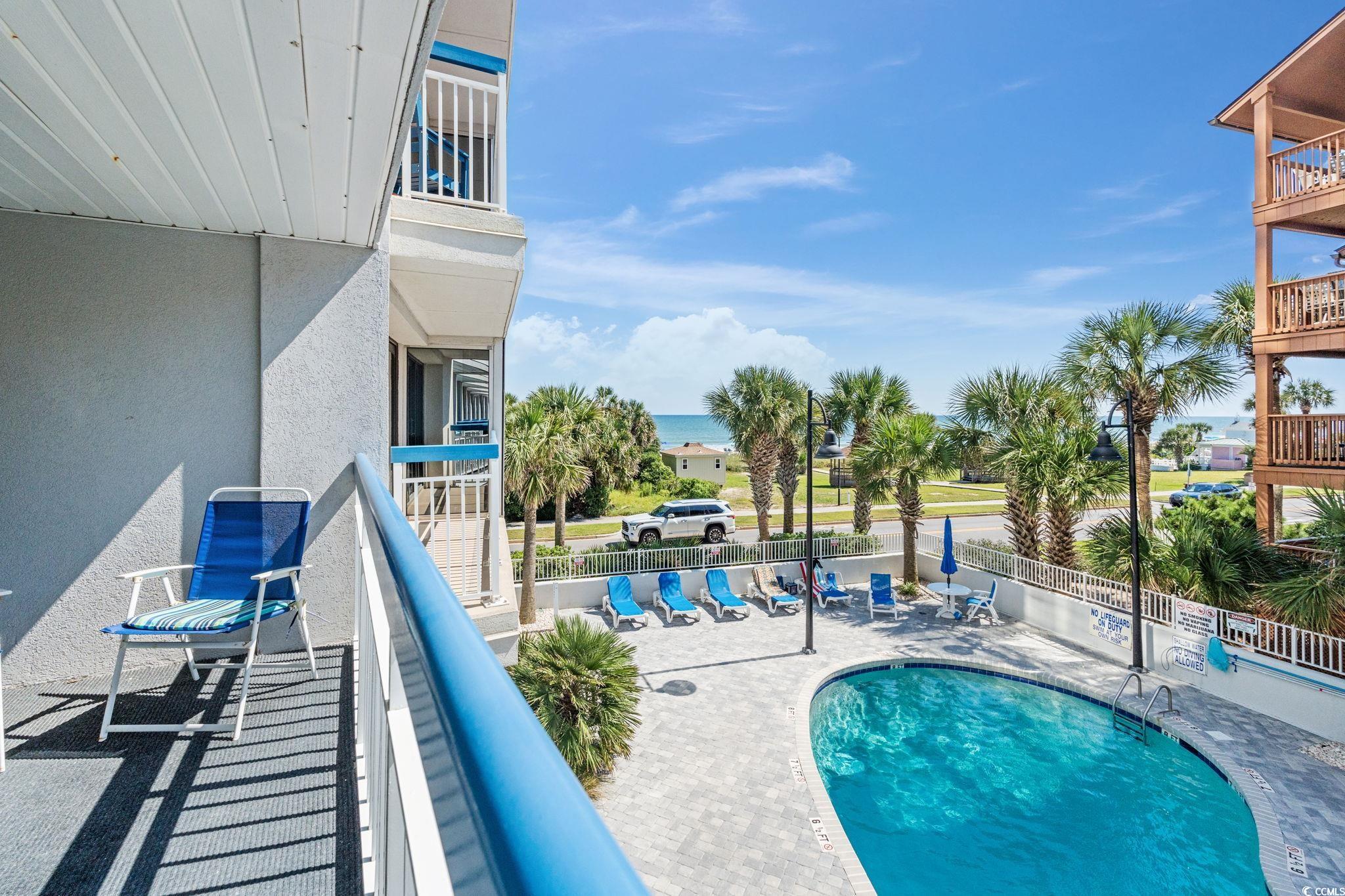 5511 North Ocean Boulevard, Unit 208 Myrtle Beach, SC 29577 - Photo 3 of 37 Community pool featuring a balcony, a patio area, and a water view