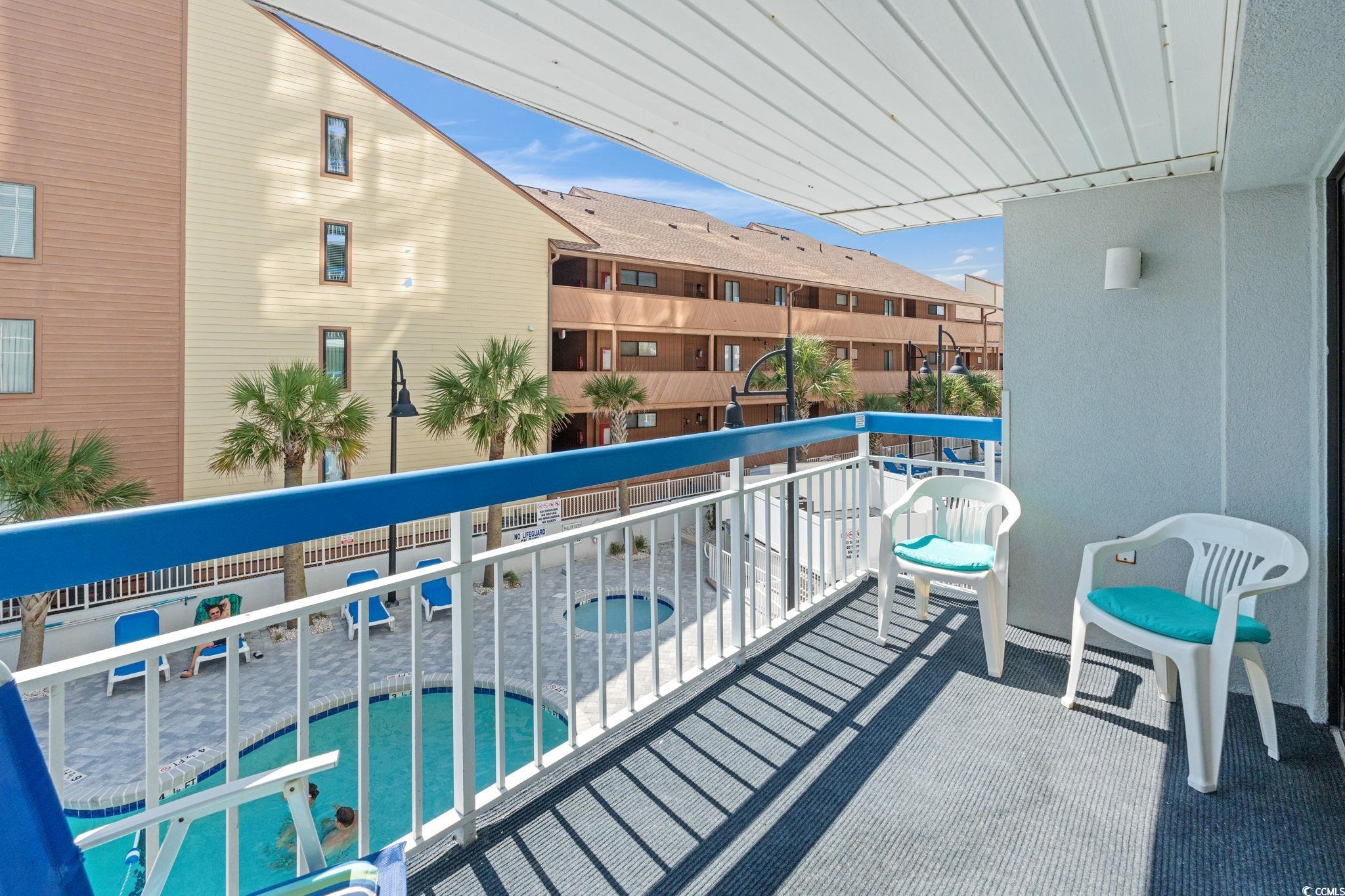 5511 North Ocean Boulevard, Unit 208 Myrtle Beach, SC 29577 - Photo 4 of 37 Balcony with a community hot tub and view of pool area