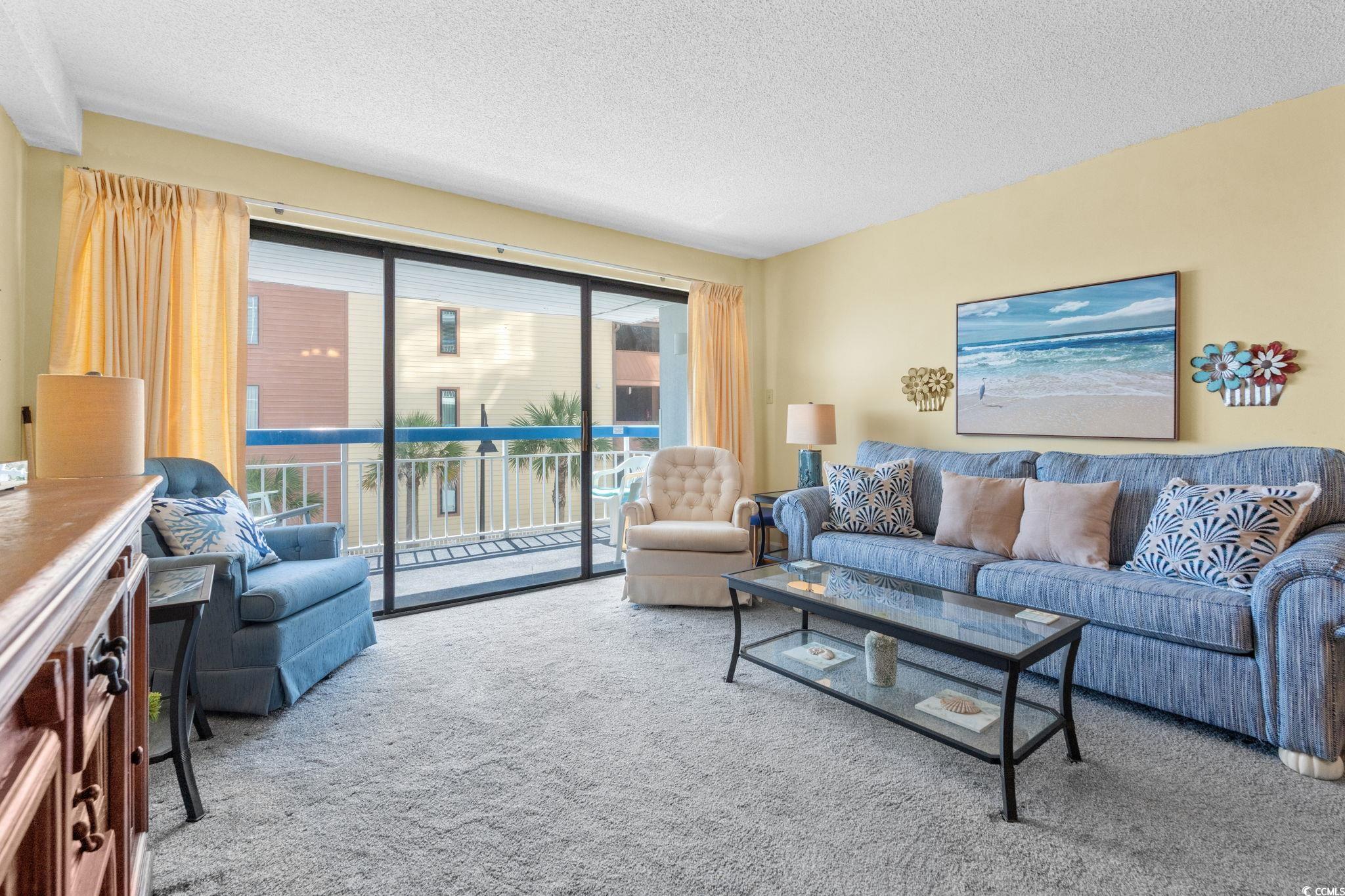 5511 North Ocean Boulevard, Unit 208 Myrtle Beach, SC 29577 - Photo 7 of 37 Living area featuring a textured ceiling and carpet flooring