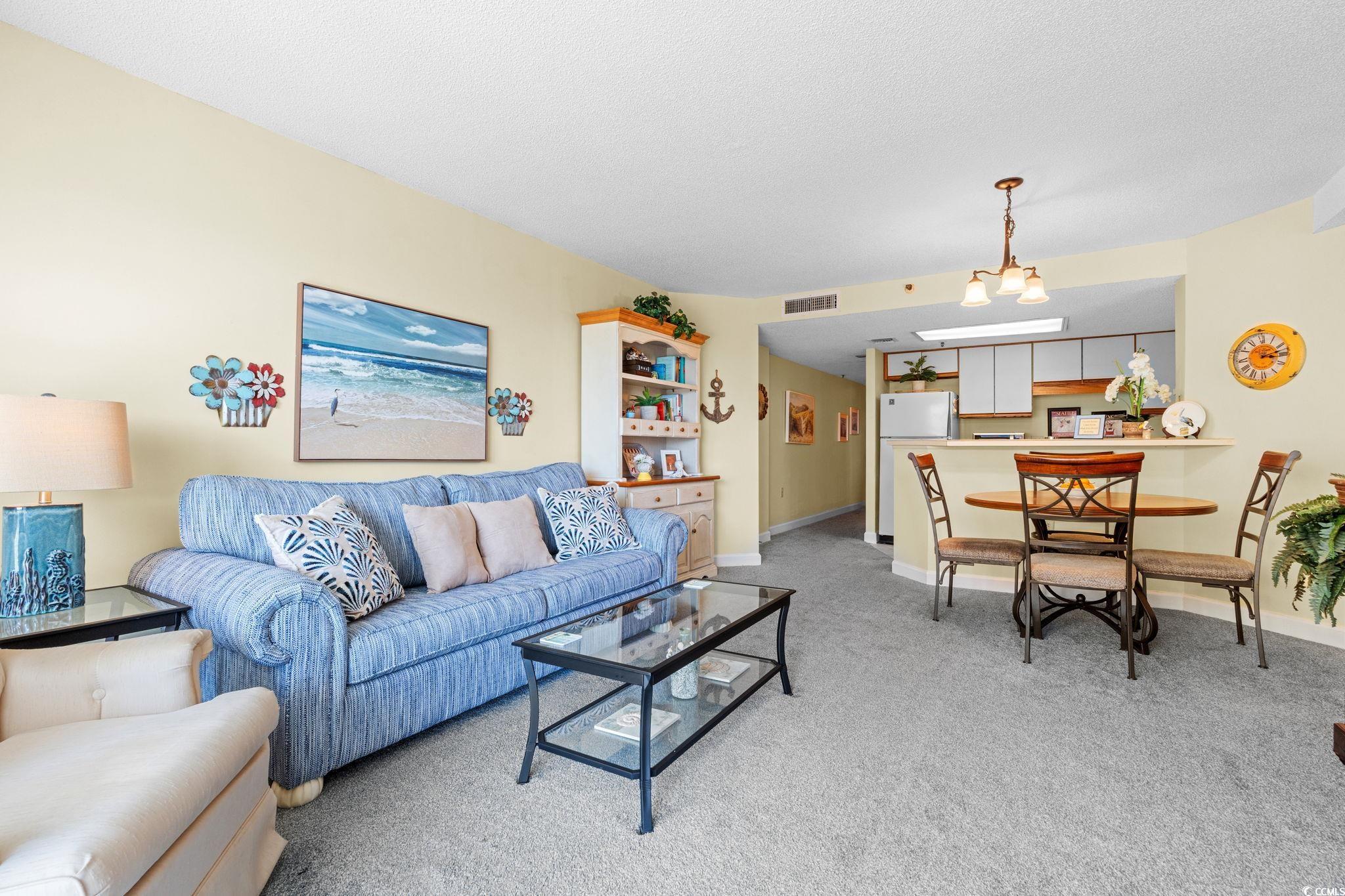 5511 North Ocean Boulevard, Unit 208 Myrtle Beach, SC 29577 - Photo 9 of 37 Living area featuring light colored carpet and baseboards