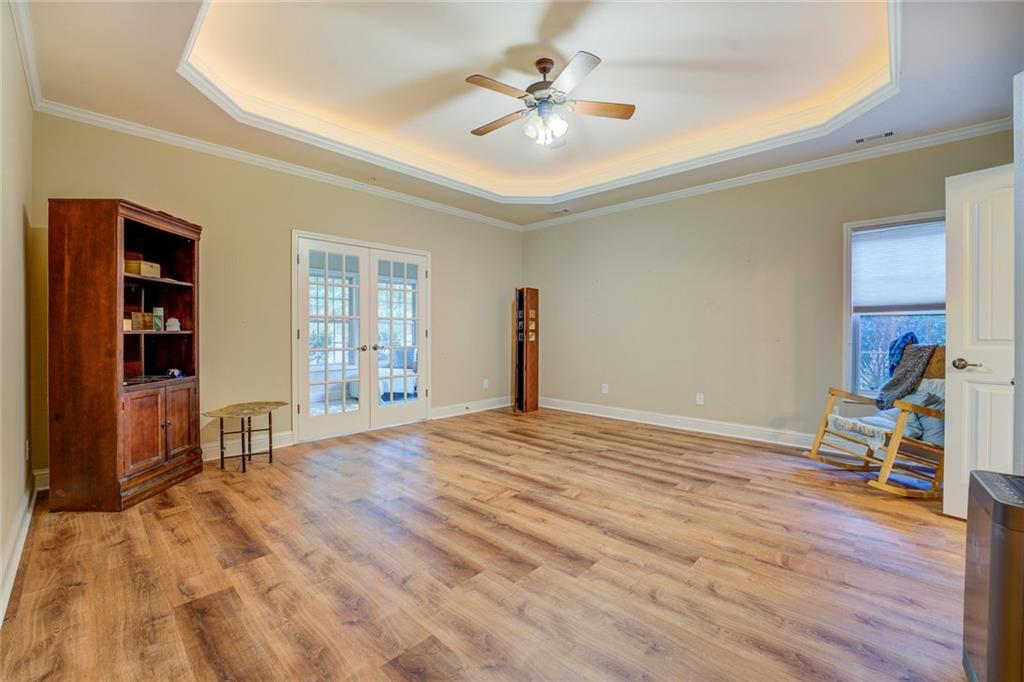 10155 Malcolm Drive Covington, GA 30014 - Photo 17 of 32 a view of a livingroom with wooden floor and a ceiling fan