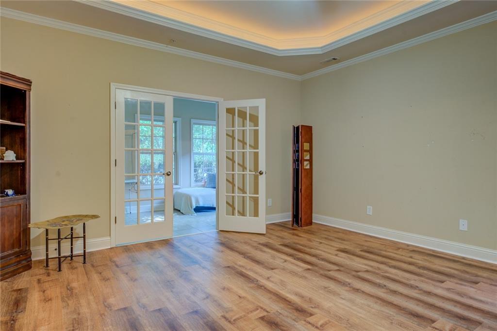 10155 Malcolm Drive Covington, GA 30014 - Photo 19 of 32 a view of an empty room with wooden floor and a window