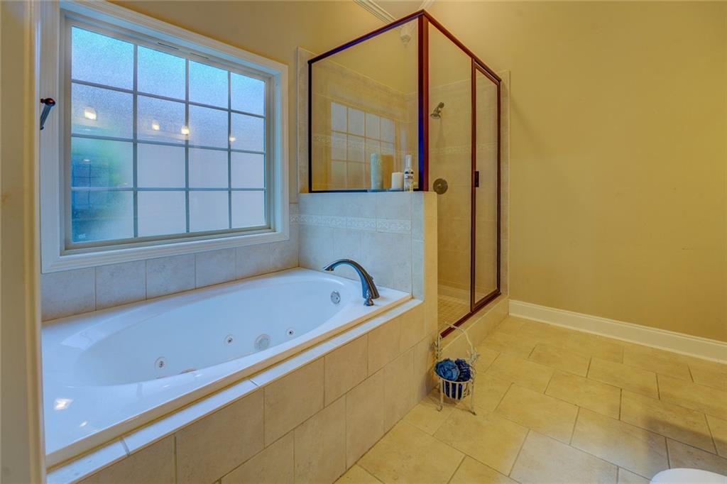 10155 Malcolm Drive Covington, GA 30014 - Photo 22 of 32 a bathroom with a tub and a shower