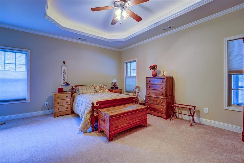 10155 Malcolm Drive Covington, GA 30014 - Photo 24 of 32 a bedroom with bed and a chandelier