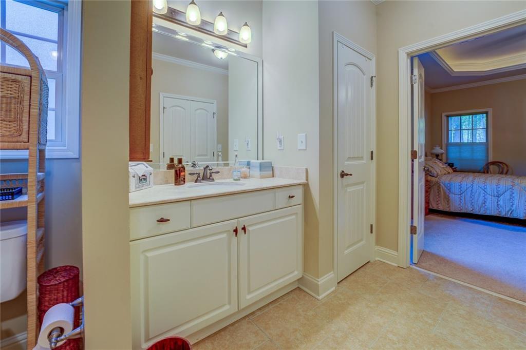 10155 Malcolm Drive Covington, GA 30014 - Photo 26 of 32 a bathroom with a sink vanity and a mirror