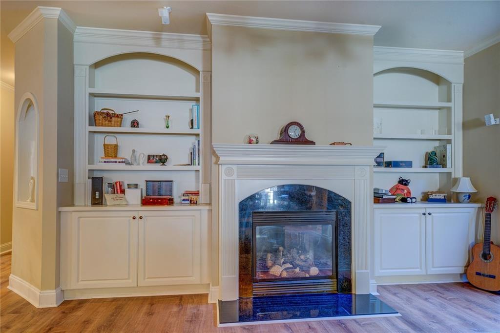 10155 Malcolm Drive Covington, GA 30014 - Photo 8 of 32 a living room with a fireplace and wooden floor