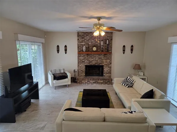 a living room with furniture and a fireplace