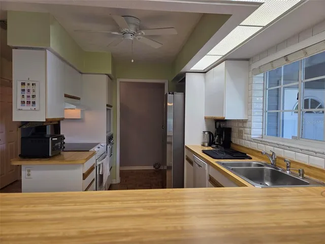 a kitchen with stainless steel appliances kitchen island granite countertop a sink and cabinets