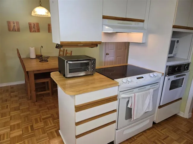 a kitchen with a stove and a microwave