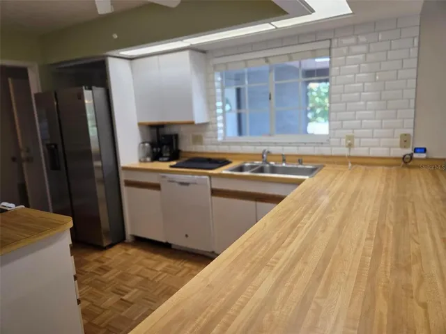 a kitchen with a sink stove and refrigerator