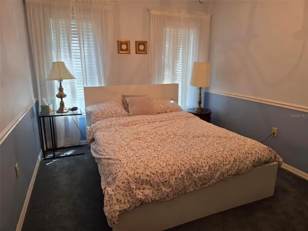 a bed sitting in a bedroom next to a window