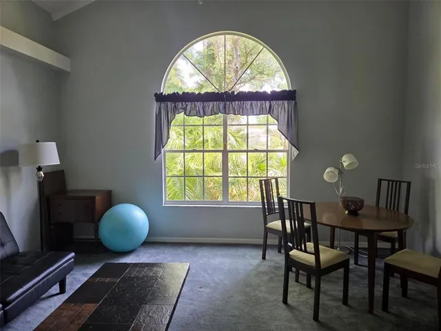 a view of a livingroom with furniture and a window