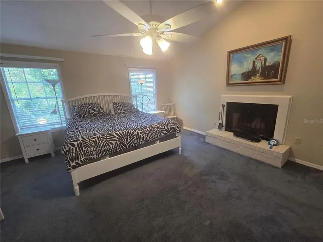 a bedroom with a bed fireplace and window
