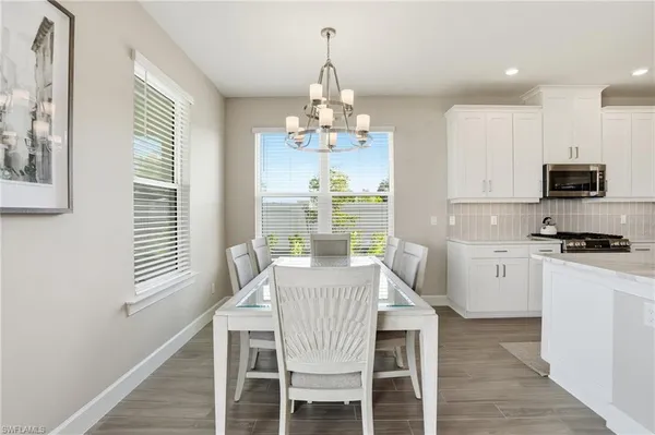 a large kitchen with a table and chairs