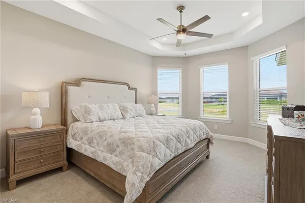a spacious bedroom with a bed and a flat screen tv
