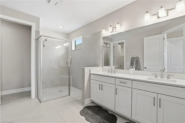 a bathroom with a glass shower door