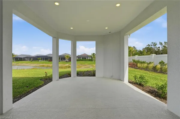a front view of a house with a garden and yard