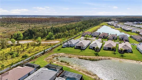 an aerial view of residential houses with outdoor space