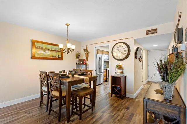 a view of a dining room with furniture wooden floor and a clock