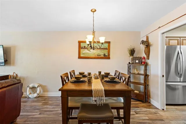 a view of a dining room with furniture wooden floor and chandelier
