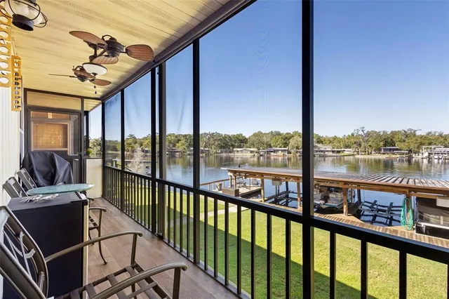 a view of a lake with lawn chairs