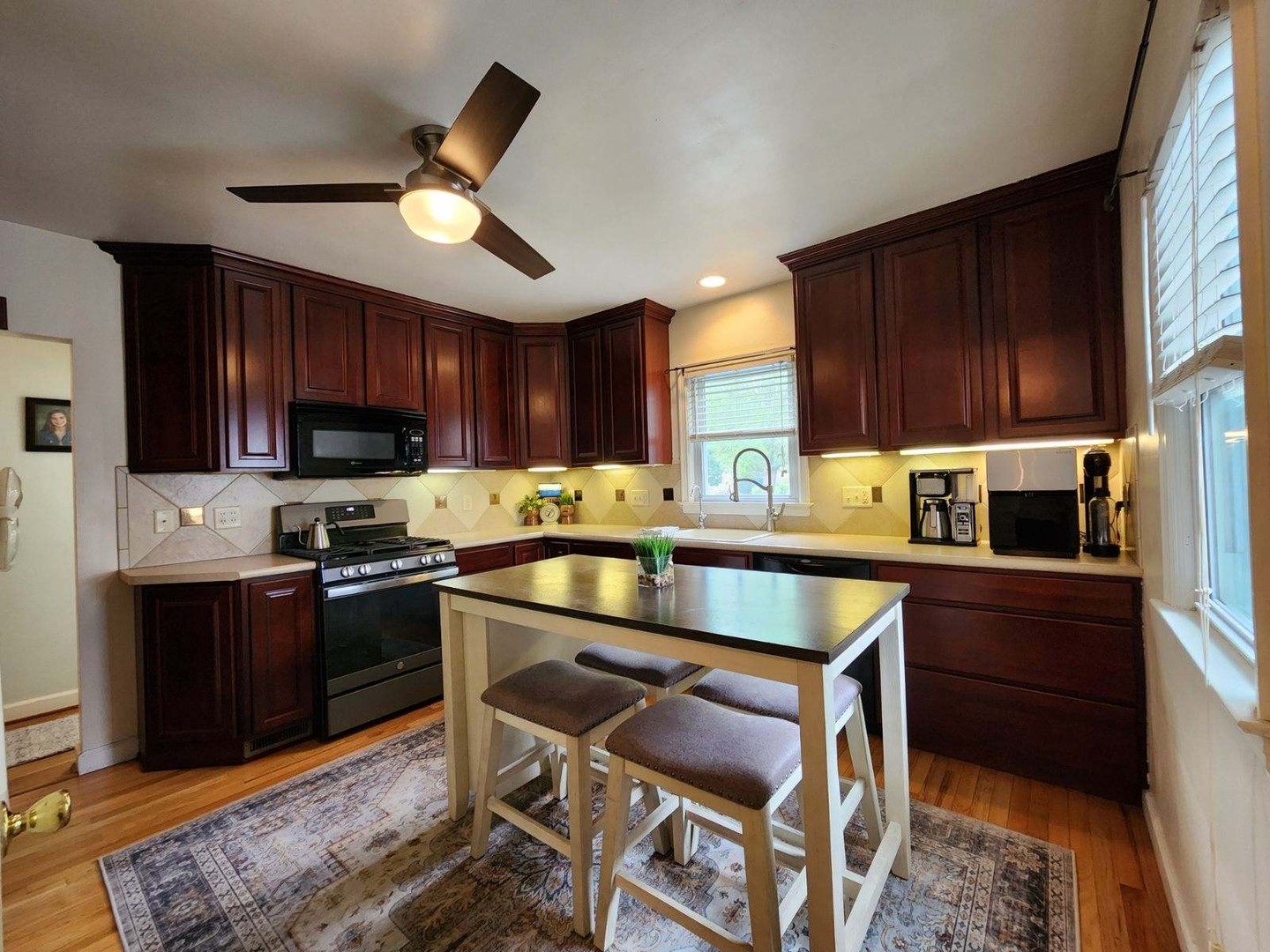 4 University Court Normal, IL 61761 - Photo 11 of 54 a kitchen with wooden cabinets and stainless steel appliances