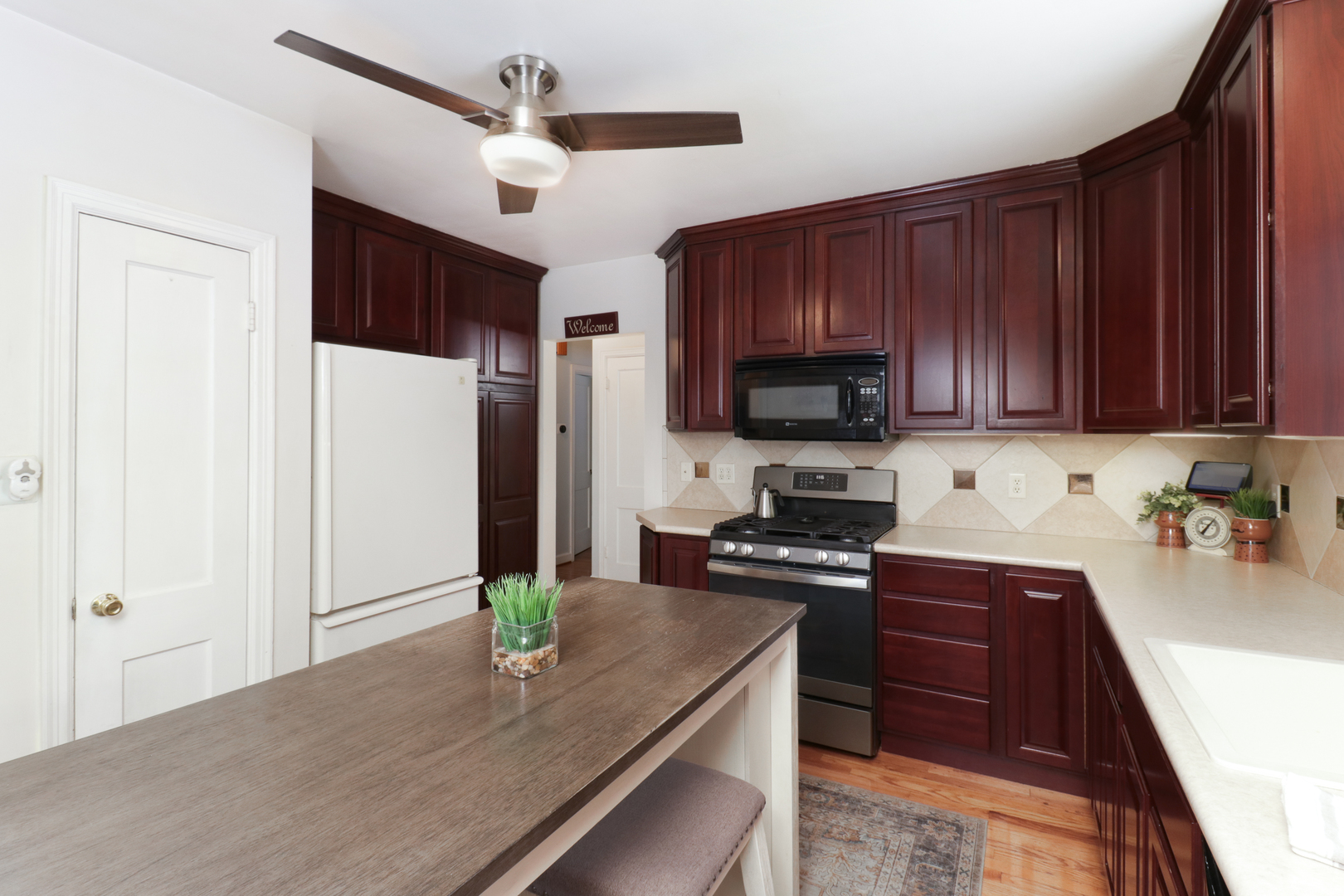 4 University Court Normal, IL 61761 - Photo 12 of 54 a kitchen with kitchen island granite countertop a stove cabinets and refrigerator