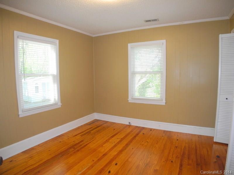 617 Blacksnake Road Stanley, NC 28164 - Photo 15 of 24 a view of an empty room with wooden floor and a window