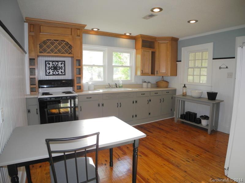 617 Blacksnake Road Stanley, NC 28164 - Photo 20 of 24 a kitchen with granite countertop a stove a sink and a refrigerator