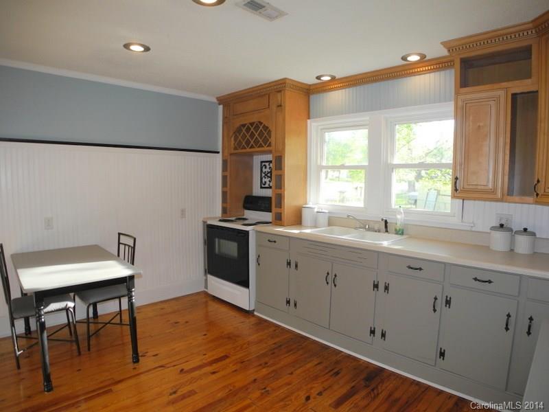 617 Blacksnake Road Stanley, NC 28164 - Photo 23 of 24 a kitchen with granite countertop a sink cabinets and wooden floor