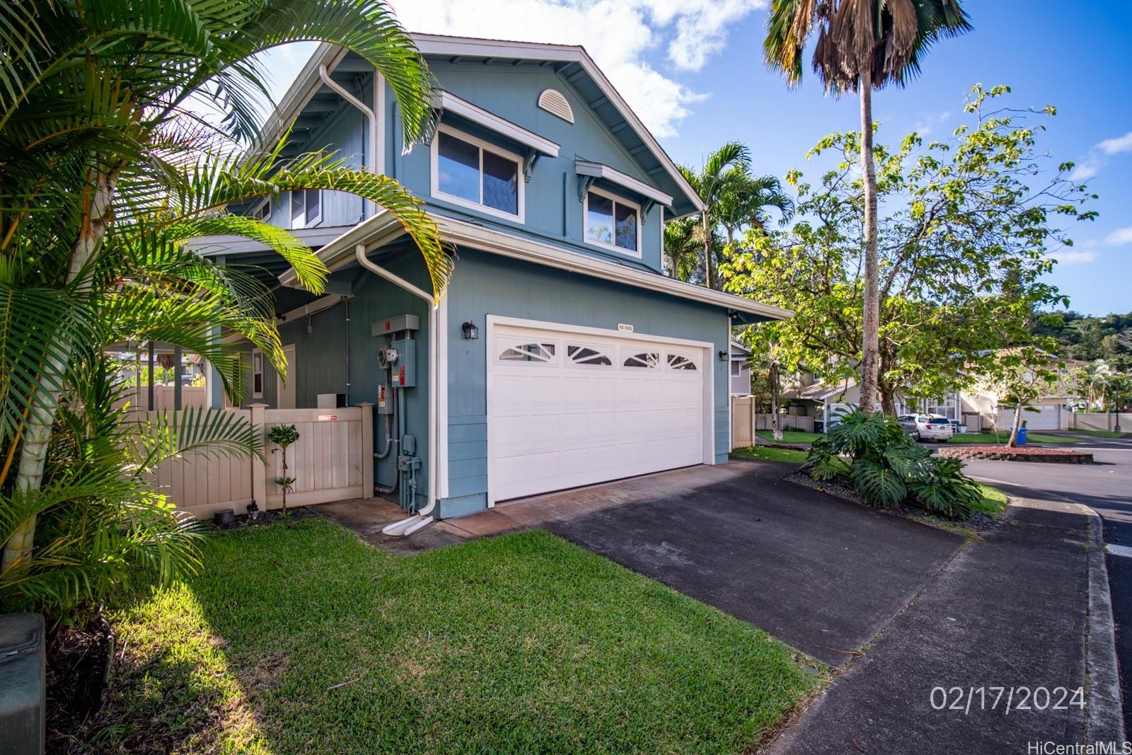 95-1085 Wikao Street Mililani, HI 96789 - Photo 1 of 1 a view of a house with a small yard and floor to ceiling window