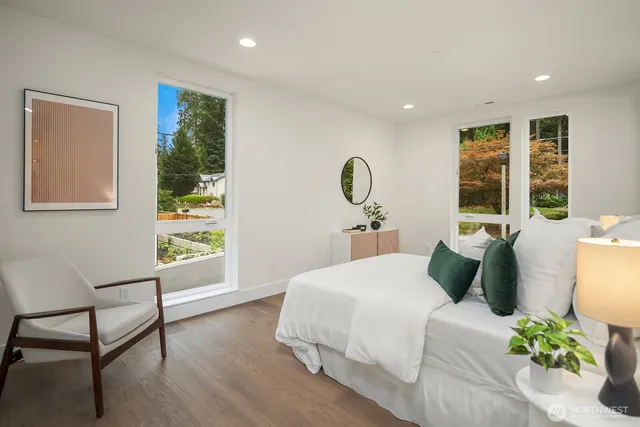 a bedroom with a large bed and a window