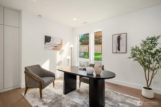a living room with furniture a window and a potted plant