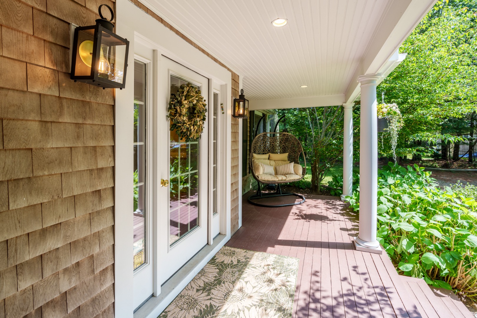 165 West Tisbury Road Edgartown, MA 02539 - Photo 4 of 29 a view of a balcony with wooden floor and garden view