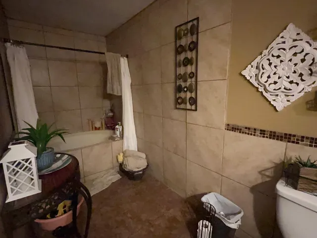 a bedroom with a bed and a lamp