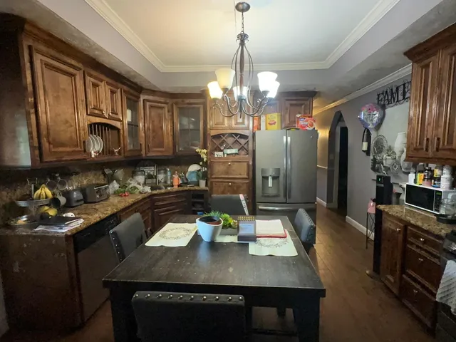 a living room with furniture a fireplace and chandelier