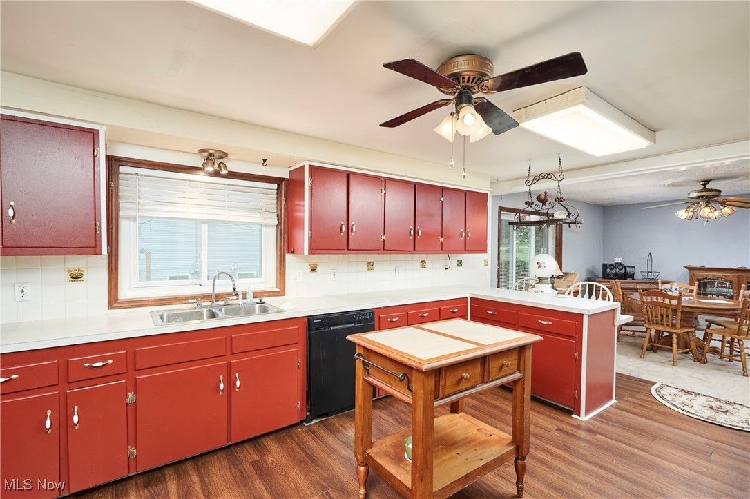 90 Johnson Road Wadsworth, OH 44281 - Photo 6 of 22 Kitchen featuring red cabinets, black dishwasher, a ceiling fan, and decorative backsplash