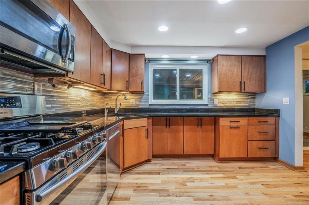 2341 Sample Road Allison Park, PA 15101 - Photo 11 of 50 a kitchen with stainless steel appliances granite countertop wooden cabinets a stove top oven a sink and dishwasher