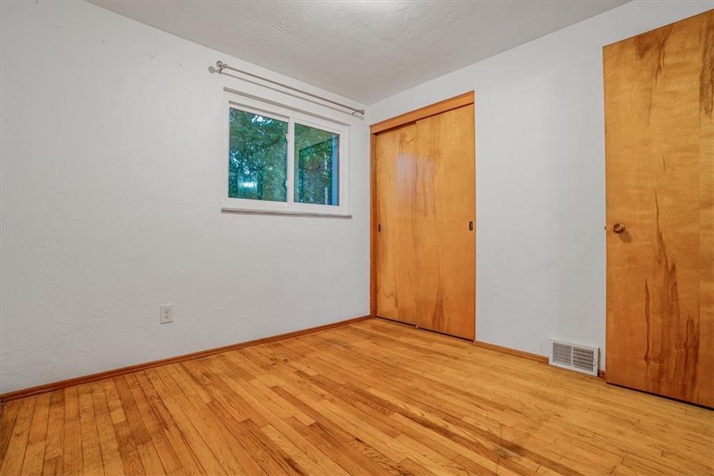 2341 Sample Road Allison Park, PA 15101 - Photo 20 of 50 a view of an empty room with wooden floor and a window